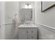 The renovated powder room boasts a modern vanity, updated mirror, and crisp white trim at 6101 Park Hill Rd, Charlotte, NC 28277