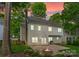 Home's backyard with a brick patio, lovely landscaping, and a traditional brick chimney at 6101 Park Hill Rd, Charlotte, NC 28277