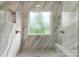 Contemporary shower is finished with marble-look tiles and features a built-in bench at 6101 Park Hill Rd, Charlotte, NC 28277