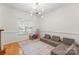 Sitting room is well lit from a large window and has a fun playful design with modular seating and colorful rug at 6101 Park Hill Rd, Charlotte, NC 28277