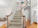 Traditional staircase leads to the upper level, showcasing wood railings and modern finishes at 6101 Park Hill Rd, Charlotte, NC 28277