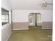 Bright living room with two-tone walls, carpet floors, ceiling fan, and sliding doors to the porch at 625 Court Side Dr, Salisbury, NC 28147
