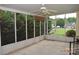 Enclosed back porch with ceiling fan, concrete floors, and views of the backyard at 625 Court Side Dr, Salisbury, NC 28147
