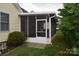 Exterior view of the enclosed porch with a well-maintained lawn and vibrant greenery at 625 Court Side Dr, Salisbury, NC 28147