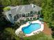 Aerial view showcases the expansive deck, outdoor hot tub and stunning pool area, perfect for entertaining at 7912 Baltusrol Ln, Charlotte, NC 28210
