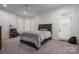 Bright bedroom with a ceiling fan and a door to the outside at 7912 Baltusrol Ln, Charlotte, NC 28210