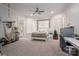 Bright bedroom with a ceiling fan, and large windows with blinds at 7912 Baltusrol Ln, Charlotte, NC 28210