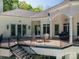 Lovely deck with plenty of seating and grilling area with stairs to the manicured lawn and pool at 7912 Baltusrol Ln, Charlotte, NC 28210