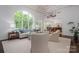 Bright living room with large windows, an open floor plan, and a view into the adjacent dining room at 7912 Baltusrol Ln, Charlotte, NC 28210