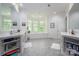 Large main bathroom with dual vanities, a soaking tub by a bay window, and tile floors at 7912 Baltusrol Ln, Charlotte, NC 28210