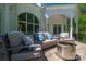 Outdoor patio with comfortable seating, a modern fire pit, and views of the lush surroundings at 7912 Baltusrol Ln, Charlotte, NC 28210