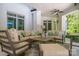 Relaxing covered patio with comfortable seating, a ceiling fan, and a view of the backyard at 7912 Baltusrol Ln, Charlotte, NC 28210