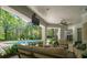 Covered patio featuring comfortable seating and a view of the pool and lush backyard at 7912 Baltusrol Ln, Charlotte, NC 28210