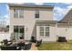 Backyard view shows a patio set, sliding glass doors to home, and a well-maintained lawn at 8424 Spirea Ct, Charlotte, NC 28215