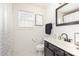Modern bathroom features a sleek vanity with black fixtures, a framed mirror, and stylish decor at 8424 Spirea Ct, Charlotte, NC 28215
