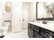 Bathroom featuring a modern vanity with dark wood and white marble top and bright mirrors at 8424 Spirea Ct, Charlotte, NC 28215