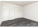 Neutral bedroom with hardwood floors has closet and door, offering comfort and privacy at 8424 Spirea Ct, Charlotte, NC 28215