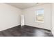 Bright bedroom features hardwood floors, a large window, and neutral paint, ready for personalization at 8424 Spirea Ct, Charlotte, NC 28215