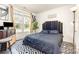 Bedroom features a black upholstered headboard, side table with lamp, and bright windows at 8424 Spirea Ct, Charlotte, NC 28215