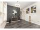 Stylish entryway with patterned accent wall, modern light fixture, hardwood floors and modern decor at 8424 Spirea Ct, Charlotte, NC 28215