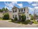 This two-story home with attached garage features neutral siding, black shutters and landscaped front yard at 8424 Spirea Ct, Charlotte, NC 28215