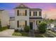 Charming two-story home features manicured lawn, black shutters, and neutral siding on a corner lot at 8424 Spirea Ct, Charlotte, NC 28215