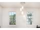 Sunlit hallway with pendant lighting fixture and neutral walls at 8424 Spirea Ct, Charlotte, NC 28215