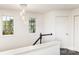 Hallway with decorative chandelier, leading to bedrooms and featuring elegant design at 8424 Spirea Ct, Charlotte, NC 28215