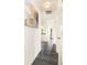 Hallway features hardwood floors, white walls, and modern art, leading to the living spaces at 8424 Spirea Ct, Charlotte, NC 28215