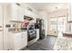 Bright kitchen features granite countertops, white cabinetry, and stainless steel appliances at 8424 Spirea Ct, Charlotte, NC 28215