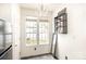 A sunlit eat-in-kitchen shows bright windows, a decorative light fixture, and floating shelves at 8424 Spirea Ct, Charlotte, NC 28215