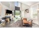 Bright living room with tall ceilings, fireplace, hardwood style floors, and access to outdoor space at 8424 Spirea Ct, Charlotte, NC 28215