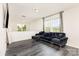 Cozy living area featuring modern gray flooring and a comfortable, plush sectional sofa at 8424 Spirea Ct, Charlotte, NC 28215