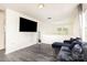 Living area with dark laminate floors and a mounted flat screen television above a half wall at 8424 Spirea Ct, Charlotte, NC 28215