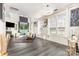 Bright living room with tall ceilings, hardwood floors, large windows and modern lighting at 8424 Spirea Ct, Charlotte, NC 28215
