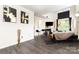 Living room with fireplace, barstools and dark laminate flooring, perfect for entertaining at 8424 Spirea Ct, Charlotte, NC 28215