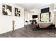 Bright living room with fireplace, modern art, and hardwood style flooring at 8424 Spirea Ct, Charlotte, NC 28215