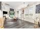 Bright living room with tall ceilings, hardwood floors, large windows and modern lighting at 8424 Spirea Ct, Charlotte, NC 28215