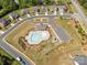 Aerial view of the community pool and playground with surrounding homes and landscaping at 8429 Golden Stone Ln, Fort Mill, SC 29707