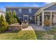 Inviting backyard with a fire pit, outdoor seating, and a well-manicured lawn at 8429 Golden Stone Ln, Fort Mill, SC 29707