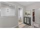 Bright bathroom featuring a glass enclosed shower and a decorative cabinet with a plant at 8429 Golden Stone Ln, Fort Mill, SC 29707