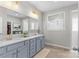 Bathroom featuring double sinks, neutral paint, and a tiled walk-in shower at 8429 Golden Stone Ln, Fort Mill, SC 29707