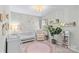 Charming Bedroom with a crib, rocker, decorative plants, and floral wall art at 8429 Golden Stone Ln, Fort Mill, SC 29707