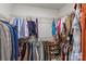 Walk-in closet with metal racks that feature hanging clothes, shoes, and purses on multiple levels at 8429 Golden Stone Ln, Fort Mill, SC 29707