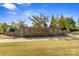 Community entrance featuring a stone sign and landscaping, creating a welcoming atmosphere at 8429 Golden Stone Ln, Fort Mill, SC 29707