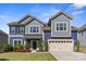 Charming two-story home with manicured lawn, craftsman details, and inviting curb appeal at 8429 Golden Stone Ln, Fort Mill, SC 29707