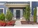 A beautifully landscaped front entrance with a decorative wreath, stone accents, and lush plantings at 8429 Golden Stone Ln, Fort Mill, SC 29707
