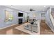 A bright living room with a large sectional sofa, fireplace, hardwood floors and a ceiling fan at 8429 Golden Stone Ln, Fort Mill, SC 29707
