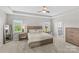 Serene main bedroom with a tray ceiling, plush carpet, and an ensuite bathroom at 8429 Golden Stone Ln, Fort Mill, SC 29707
