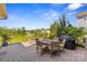 Charming outdoor patio with a dining set, grill, and serene views at 8429 Golden Stone Ln, Fort Mill, SC 29707